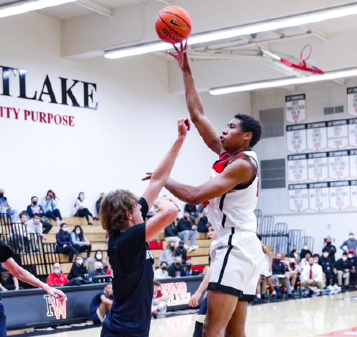 ﻿ Landon Lewis of Harvard-Westlake shoots over Dusty Stromer of Sherman Oaks Notre Dame. Photo by Craig Weston.