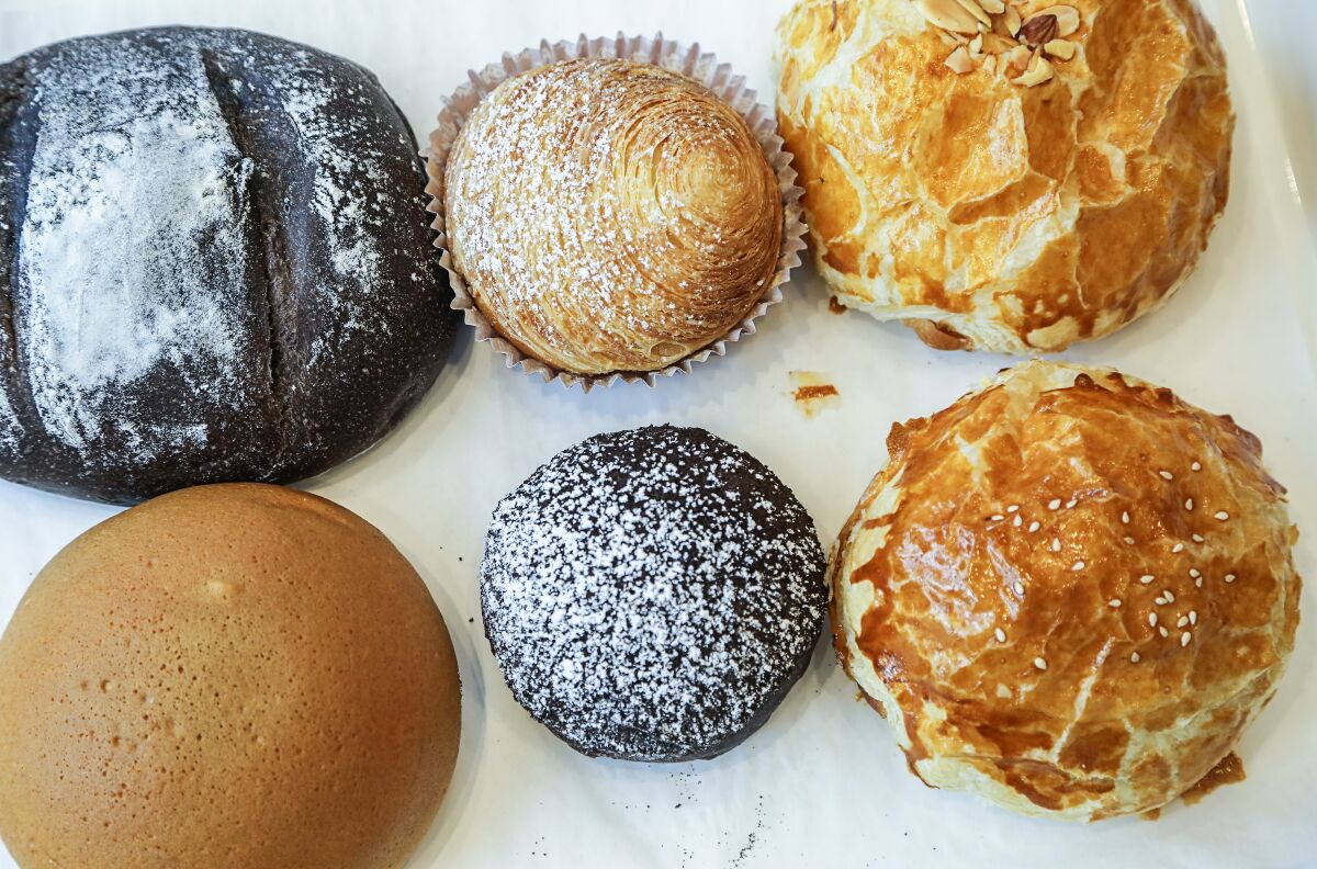 This tray of breads from 85°C  exemplifies the chain's signature flavor profiles, delicate pastry dough and not-too-sweet touch. They are (clockwise from top left): subtle chocolate cream cheese; ultra-flaky taro twist; milk butter puff pastry, with condensed milk filling; well-balanced taro puff pastry; chocolate cookie bread (which tastes like a great breakfast cereal); and the espresso bun.