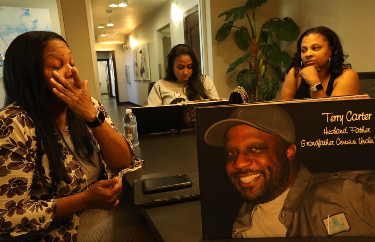 Terry Carter's wife, Lillian, left, with daughters Crystal and Nekaya, right, remember the patriarch of their family in Marina del Rey.