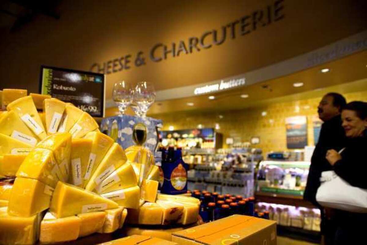Shoppers browse the "Cheese and Charcuterie" section of Whole Foods Market in El Segundo. Cheese and meats were more expensive in the first quarter of 2012.