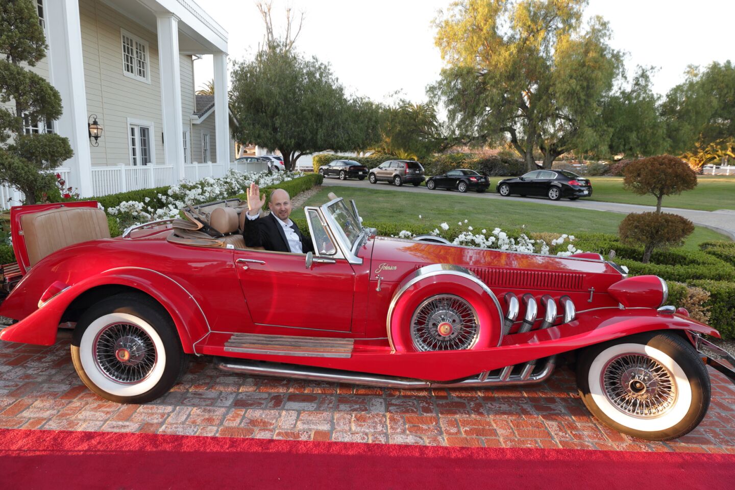 Peter Tomson in a mirror image of a 1935 Duesenberg Roadster Convertible built in 1985 by Johnson Motor Company