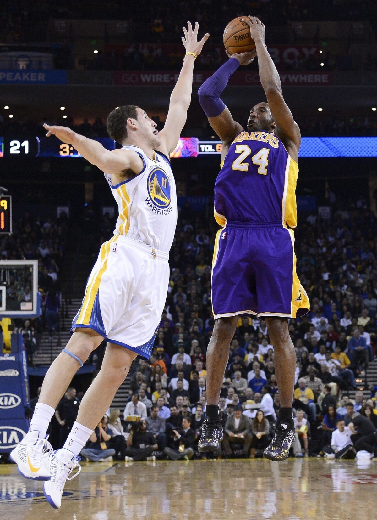 Lakers guard Kobe Bryant shoots over Warriors guard Klay Thompson.