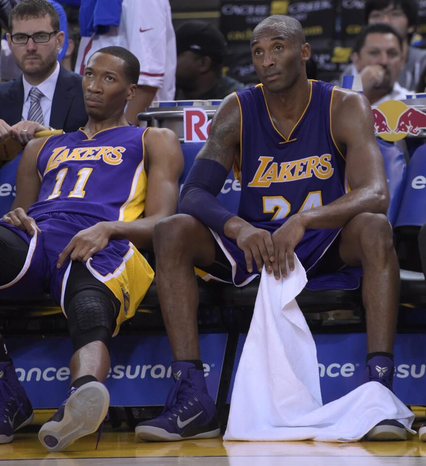 Wesley Johnson and Kobe Bryant don't like what they see from the bench Saturday in the final minutes of the Lakers' blowout loss to Golden State in Oakland.