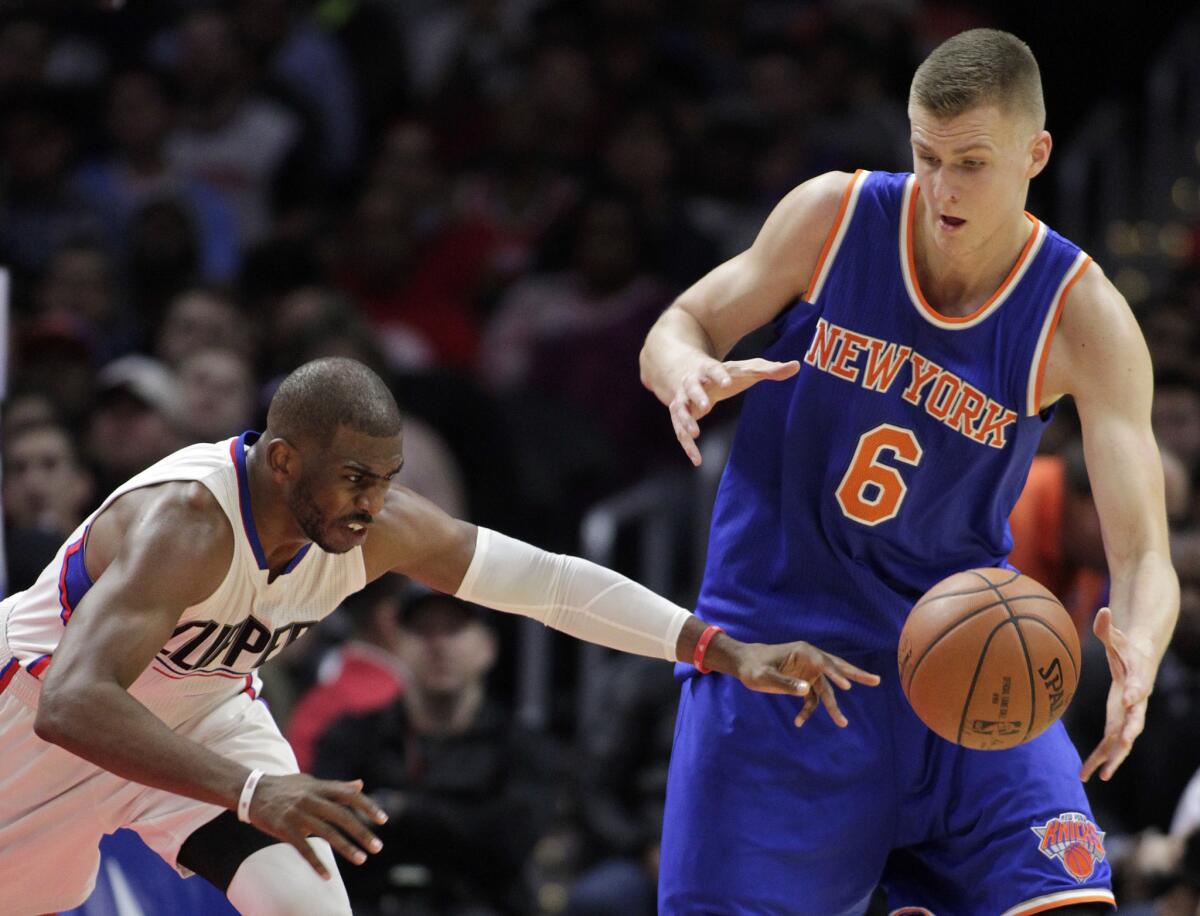 Clippers guard Chris Paul loses the ball next to Knicks forward Kristaps Porzingis (6) during the second half Friday night at Staples Center.