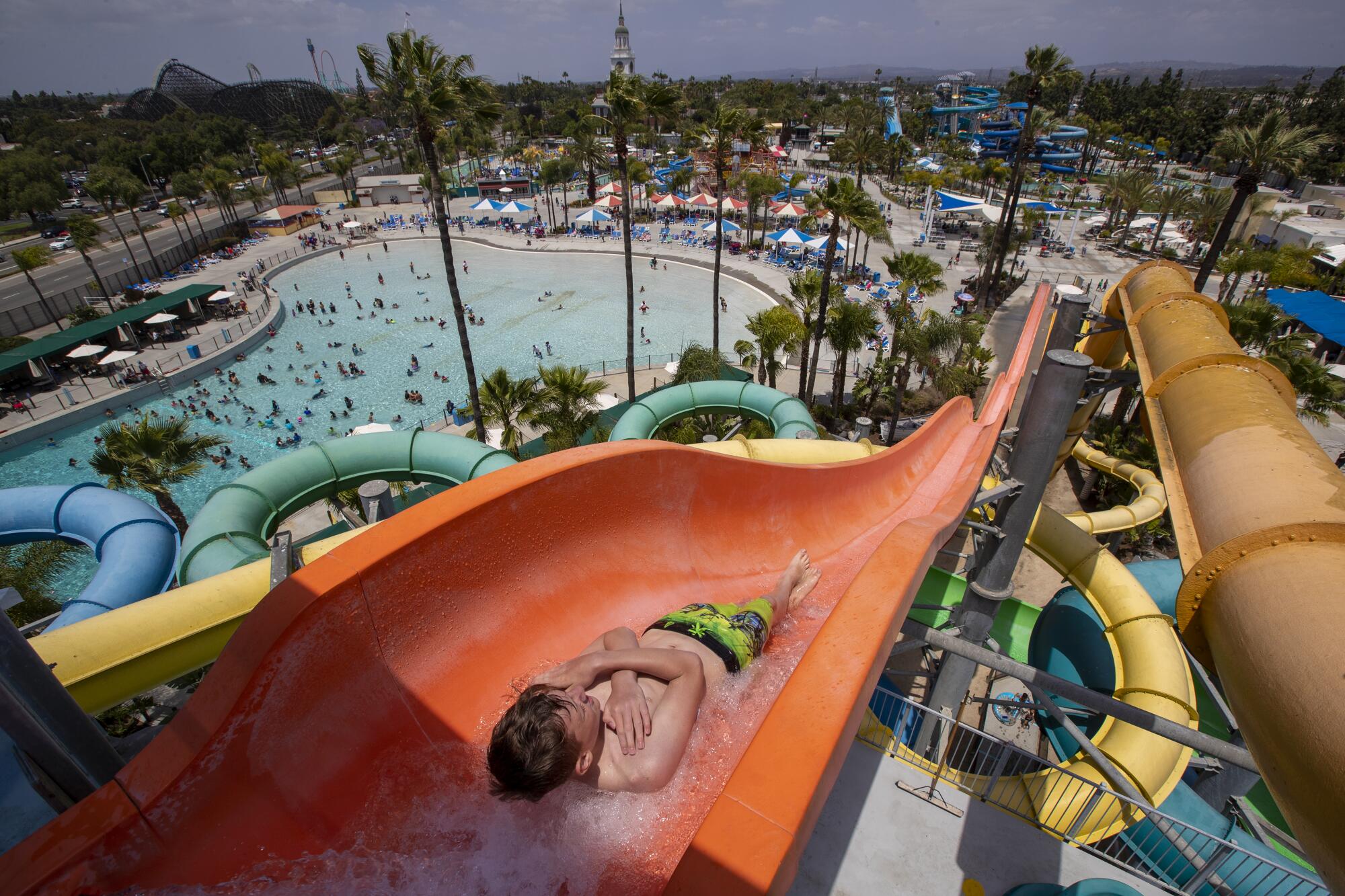 A boy drops down Riptide slide atop the 63-foot-high Old Man Falls.