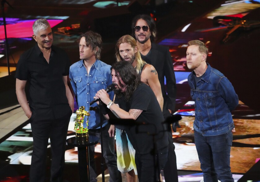 Six men onstage accepting an award