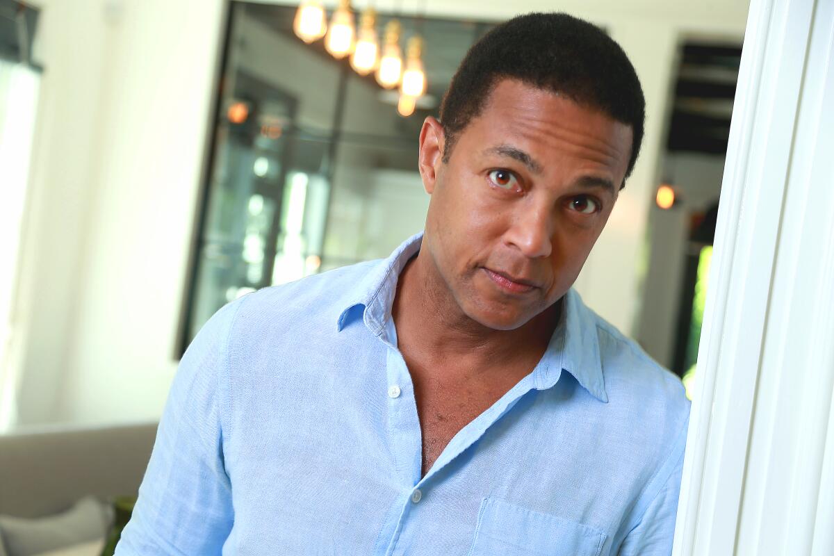 Don Lemon looks up while leaning on a door frame.