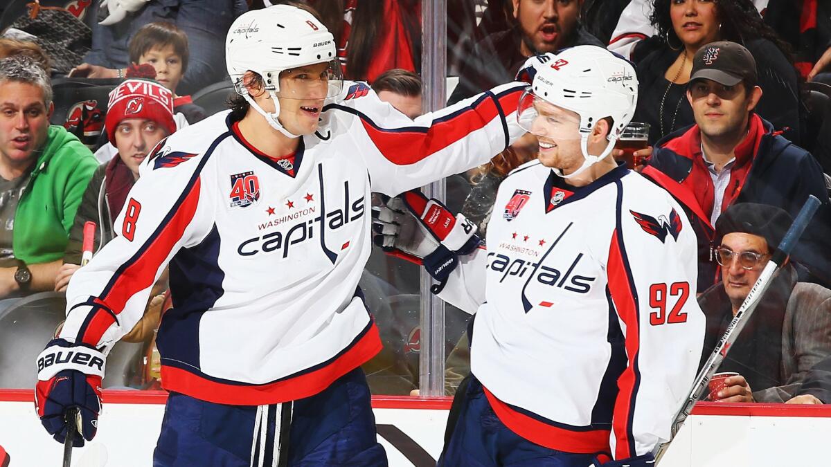 Washington Capitals captain Alex Ovechkin, left, celebrates with teammate Evgeny Kuznetsov after scoring against the New Jersey Devils on Saturday.