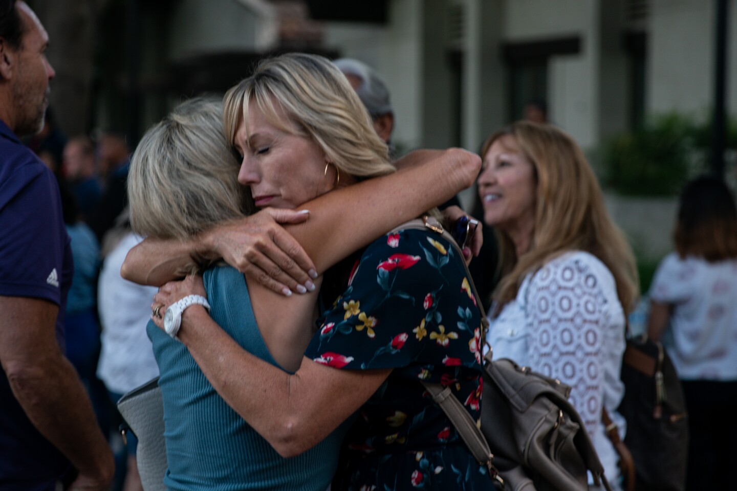 GILROY, CALIF. - JULY 29: Kelly Ramirez, of Gilroy gives a hug, after a candlelight vigil at Gilroy City Hall on Monday, July 29, 2019 in Gilroy, Calif. (Kent Nishimura / Los Angeles Times)