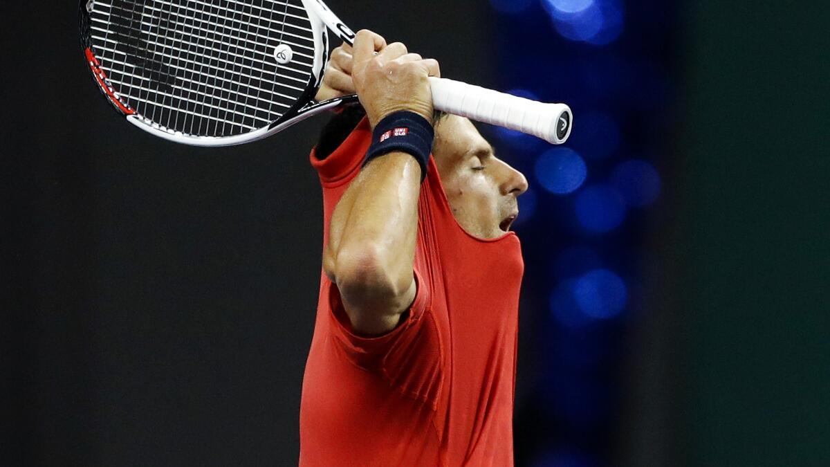 Novak Djokovic rips his shirt off after losing to Roberto Bautista Agut in the Shanghai Masters semifinals on Saturday.