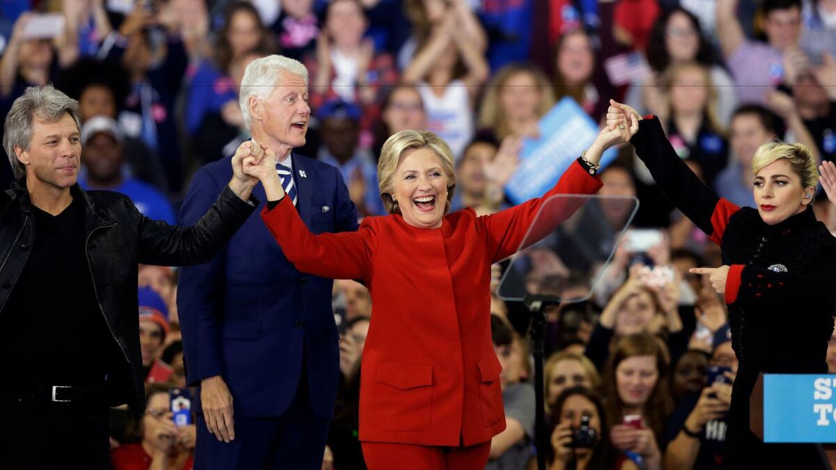 Hillary Clinton is joined by Jon Bon Jovi, left, Lady Gaga and husband Bill Clinton at a North Carolina campaign rally on Monday. (AP Photo / Gerry Broome)