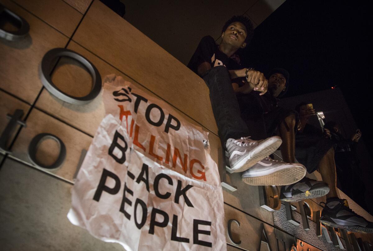 Justin Mullen listens to a speaker outside LAPD headquarters during a Black Lives Matter protest.