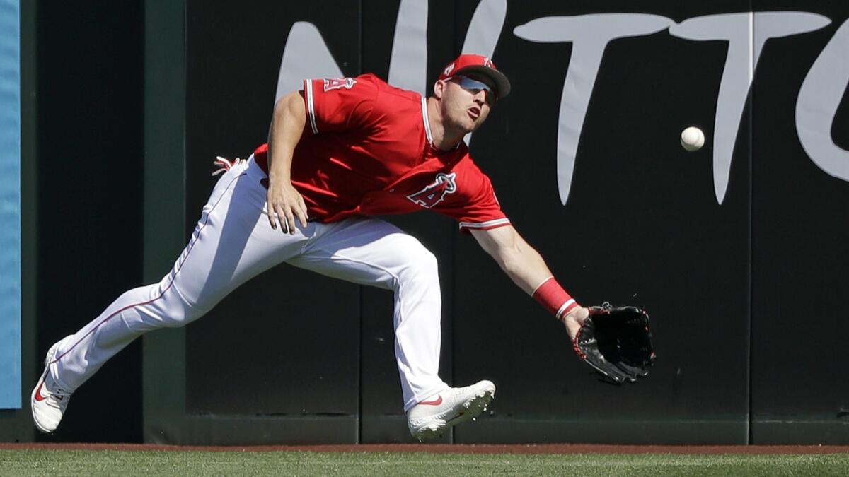 Angels center fielder Mike Trout can't come up with a double by Chicago Cubs catcher Willson Contreras in the first inning. Trout kicked the ball away and Contreras scored on the error.
