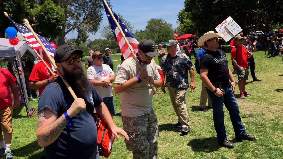 Supporters of President Trump join a Make America Great Again rally at Mile Square Regional Park in Fountain Valley on Saturday.