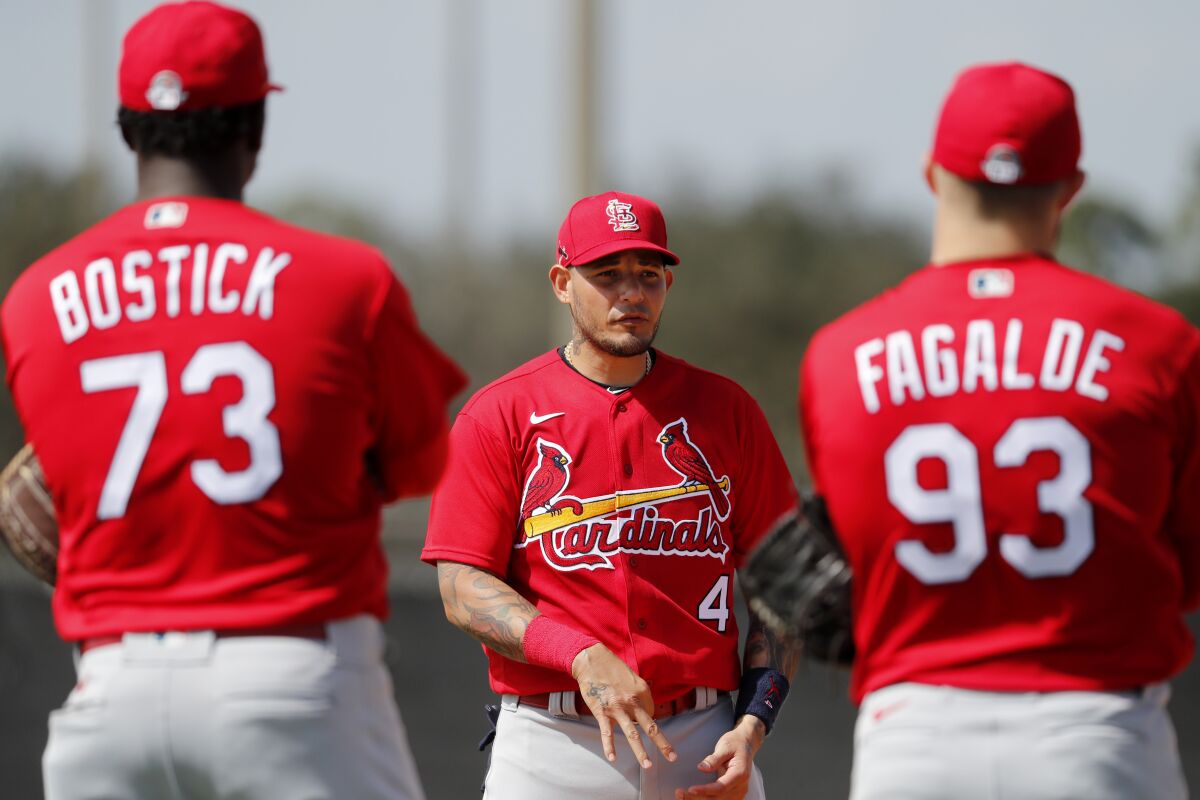 St. Louis Cardinals catcher Yadier Molina (4) talks with pitchers Akeem Bostick (73) and Alex Fagalde (93) during spring training baseball practice Wednesday, Feb. 12, 2020, in Jupiter, Fla. (AP Photo/Jeff Roberson)