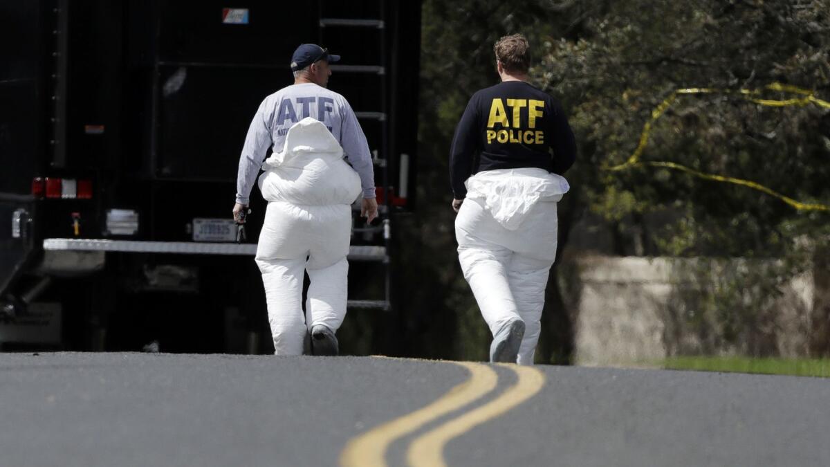 Federal investigators work near the site of an explosion Sunday in Austin, Texas. Another explosion occurred early Tuesday at a FedEx facility near San Antonio, Texas.