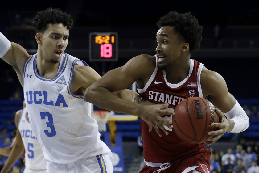 Stanford guard Bryce Wills drives around UCLA guard Jules Bernard during the first half on Wednesday at Pauley Pavilion.