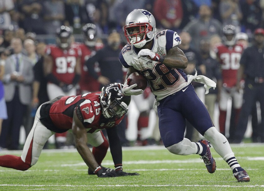 Patriots running back James White evades Falcons defensive back Deion Jones on a big gain during the fourth quarter.