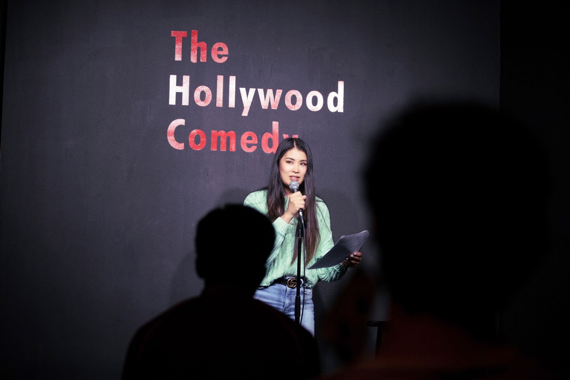 A woman at a mic onstage