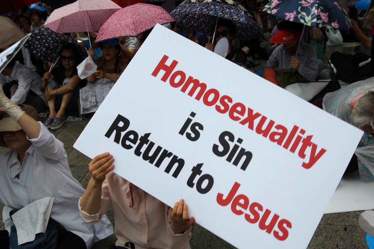Anti-gay activists attend a rally next to the Korea Queer Culture Festival in front of City Hall in Seoul on June 11, 2016.