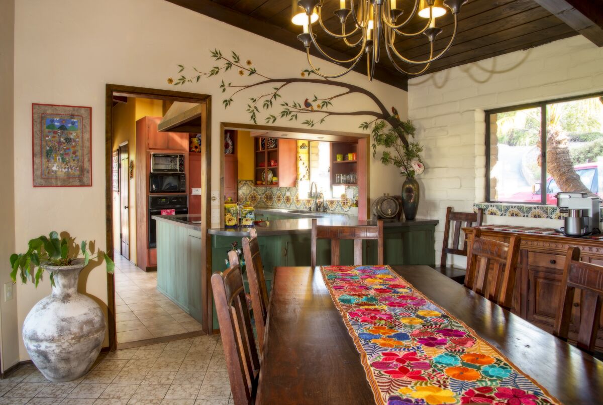 The dining area of the Krichman Adobe features the whimsical style and bright colors favored by the current owner.