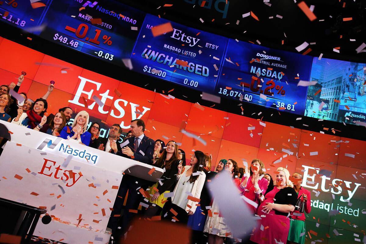 Employees and sellers of the online marketplace Etsy stand with CFO Kristina Salen on the floor of Nasdaq at the start of trading.