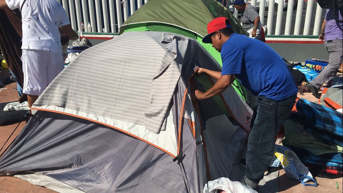 Volunteers tear down the makeshift camp from the Central American caravan last month.