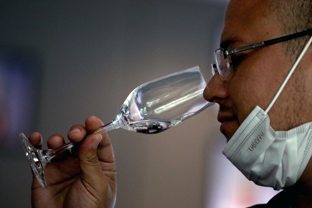 A man sniffs a glass of tequila