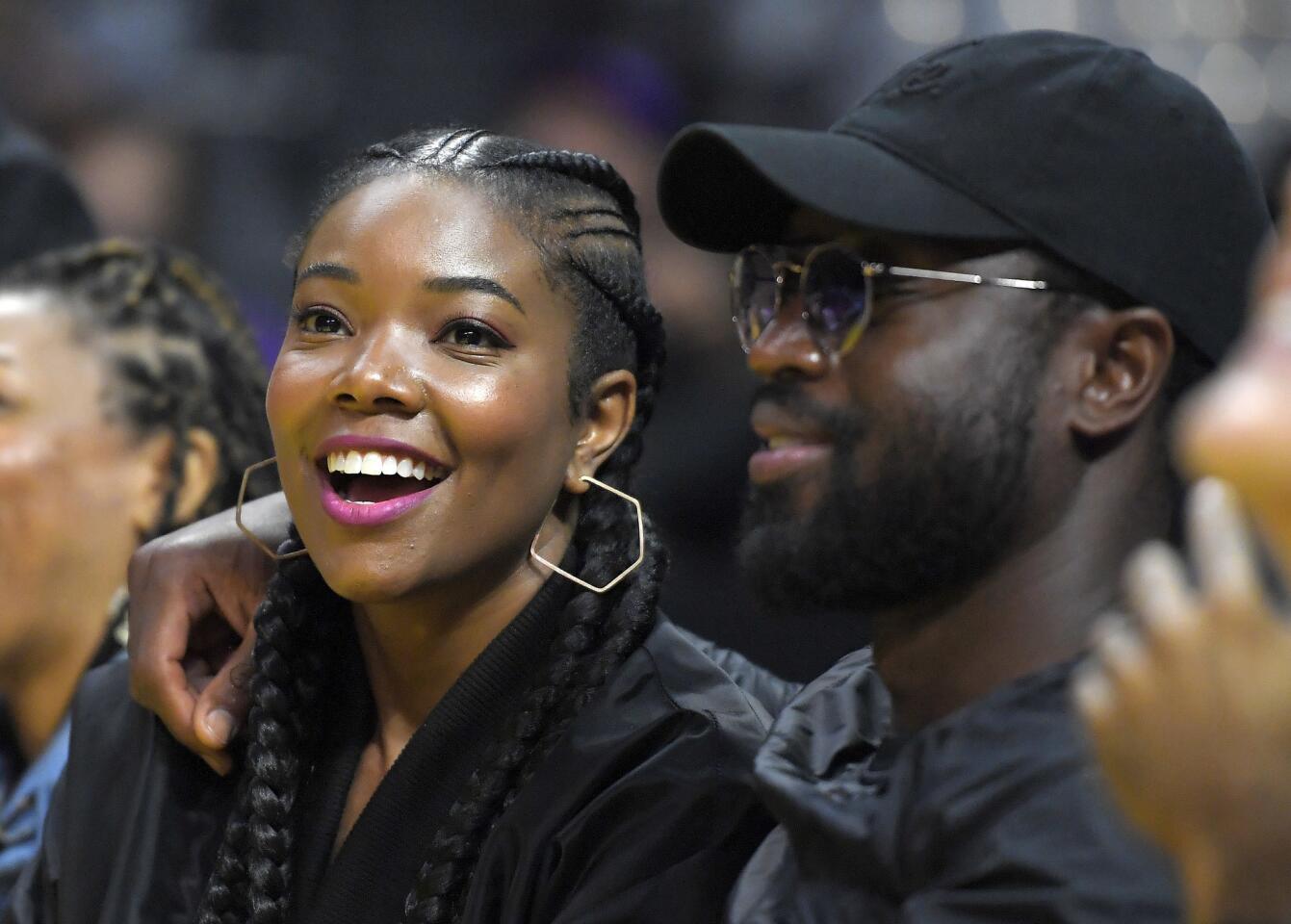 Chicago Bulls Dwyane Wade, right, watches with actress Gabrielle Union during the first half of a WNBA basketball game between the Los Angeles Sparks and the Atlanta Dream, Friday, Sept. 1, 2017, in Los Angeles. (AP Photo/Mark J. Terrill)
