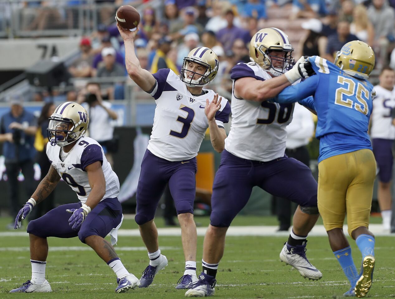 Washington quarterback Jake Browning throws downfield against UCLA in the first quarter on Saturday at the Rose Bowl.