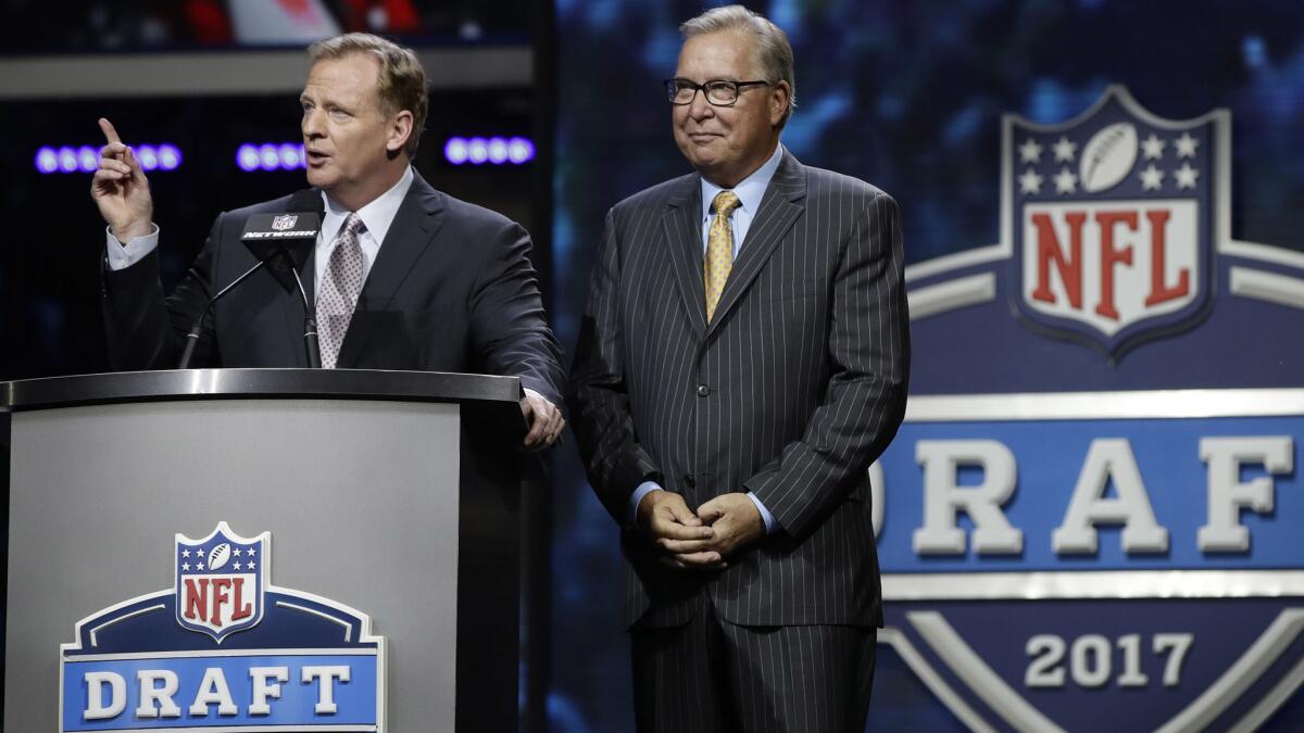 NFL commissioner Roger Goodell, left, and former Philadelphia Eagles quarterback Ron Jaworski address the crowd in Philadelphia before the start of the NFL draft's second round.