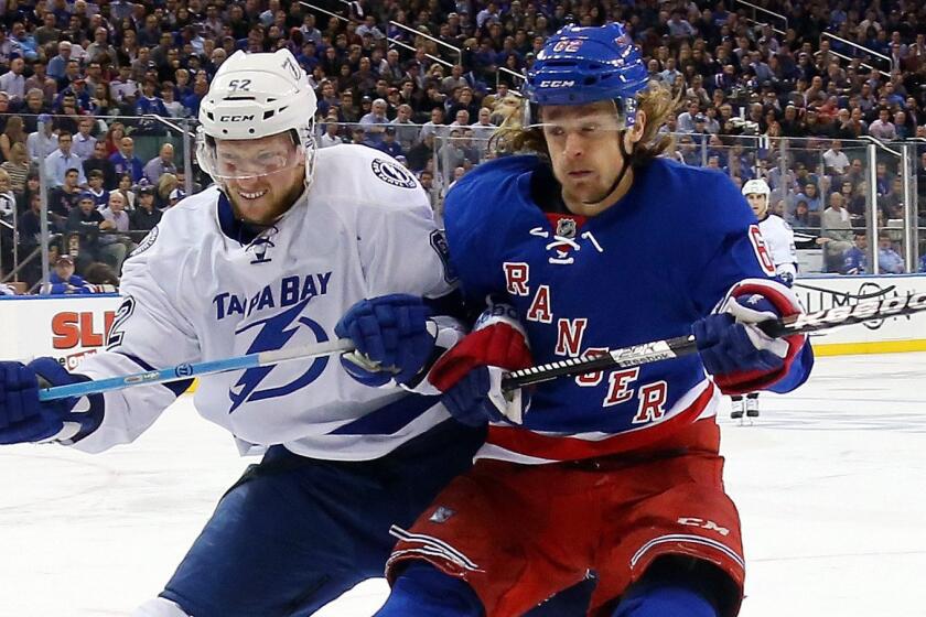 New York Rangers forward Carl Hagelin, right, battles Tampa Bay Lightning defenseman Andrej Sustr during a playoff game on May 29. Hagelin was acquired by the Ducks on June 27.
