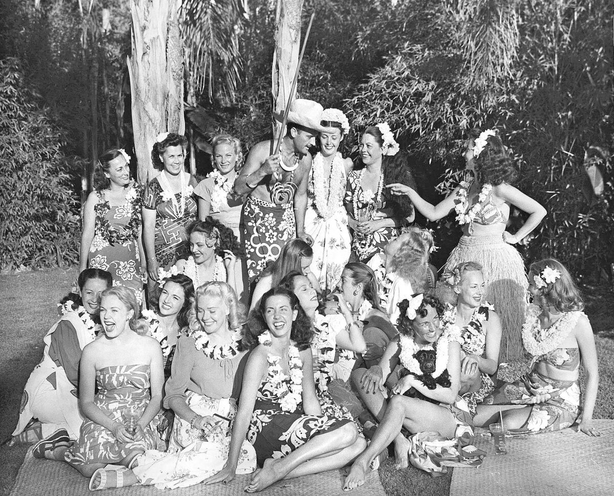 Donn Beach, surrounded by starlets at his backyard luau in 1946.