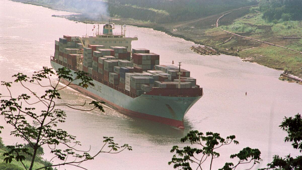 A container ship transits the "Gaillard Cut" section of the Panama Canal, 22 miles from Panama City, on Dec. 27, 1999.
