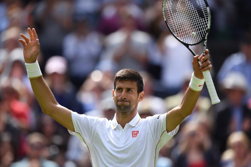 Novak Djokovic celebrates his first round victory against James Ward at Wimbledon.