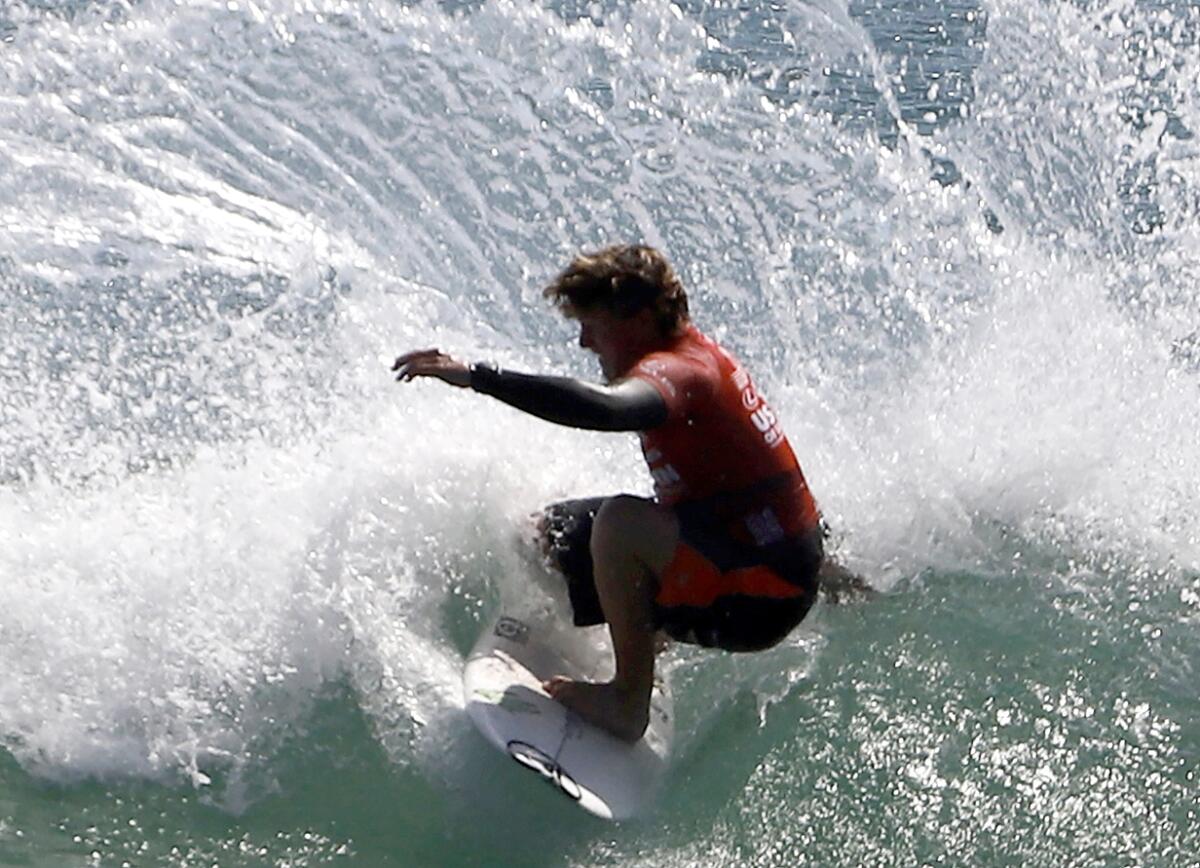 Alan Cleland of Mexico makes a sharp turn during the U.S. Open of Surfing final on Sunday afternoon in Huntington Beach.