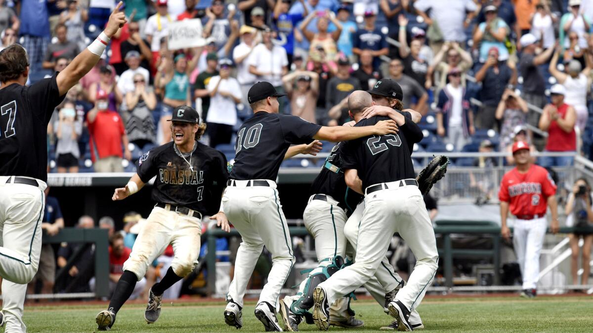 Coastal Carolina players celebrate after defeating Arizona in the deciding game at the College World Series on Thursday.