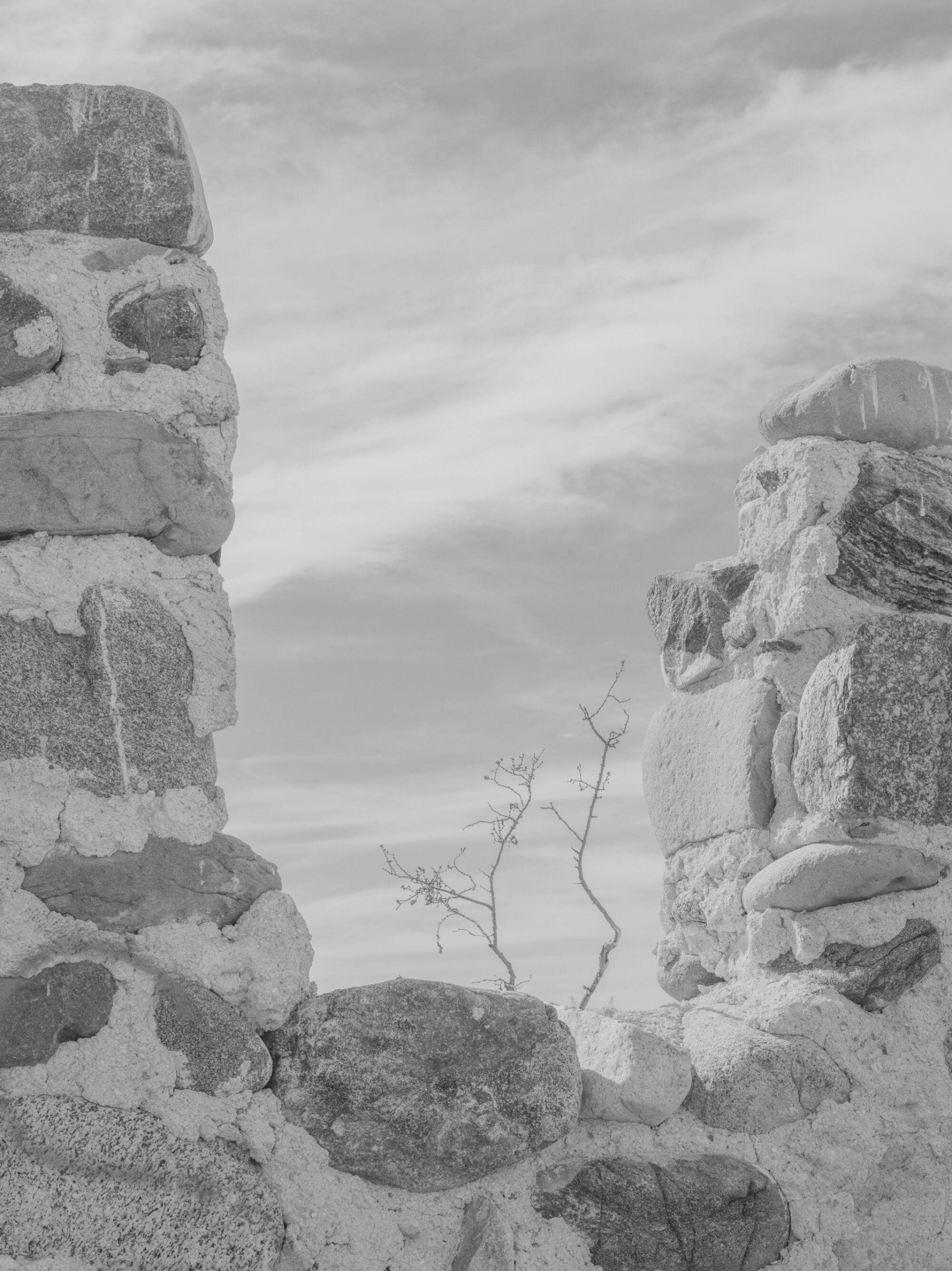 A black and white, closeup image of stone ruins.