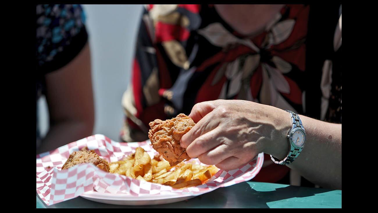Doris Ito tries the deep-fried filet mignon from Chicken Charlie's at the Orange County Fair.