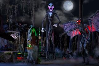 A 13 foot animated Jack Skellington is set up in a spooky front-yard display. 