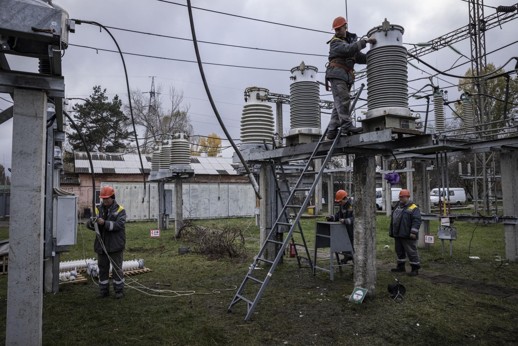 Workers repair a power station.