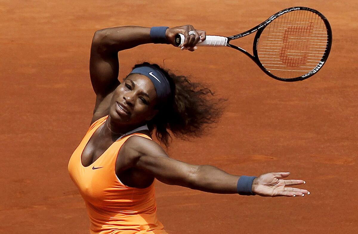 Serena Williams returns a shot against Maria Kirilenko at the Madrid Open.