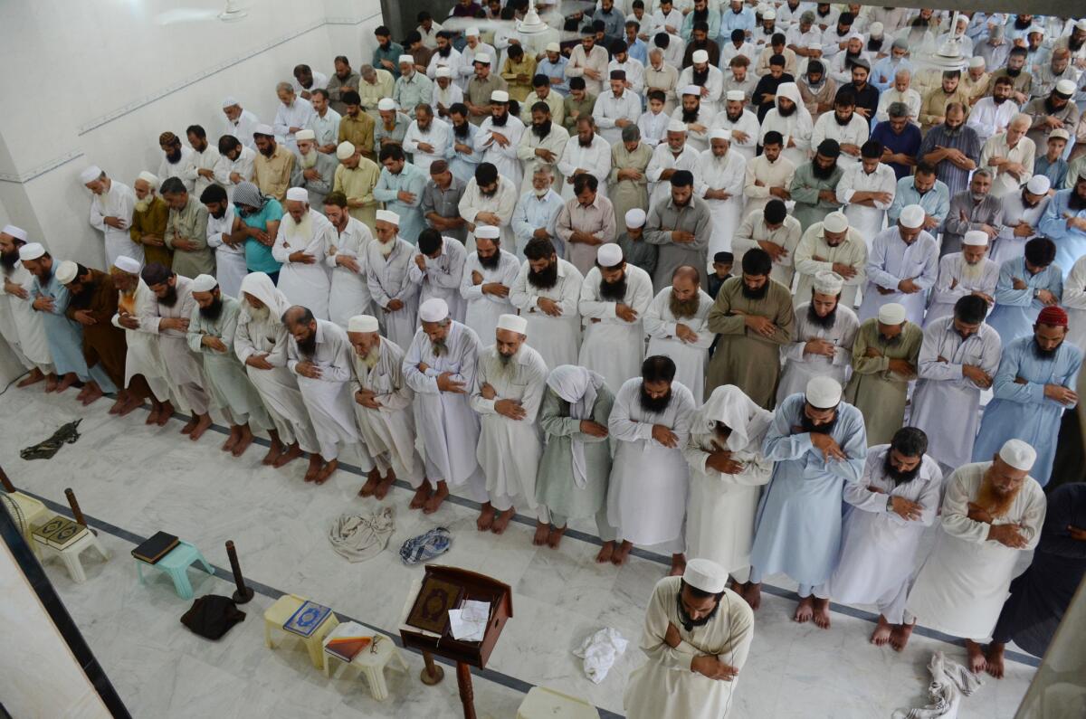 Worshippers offer funeral prayers for the Taliban's late leader, Mullah Mohammad Omar, at a mosque in Peshawar, Pakistan, on Friday.