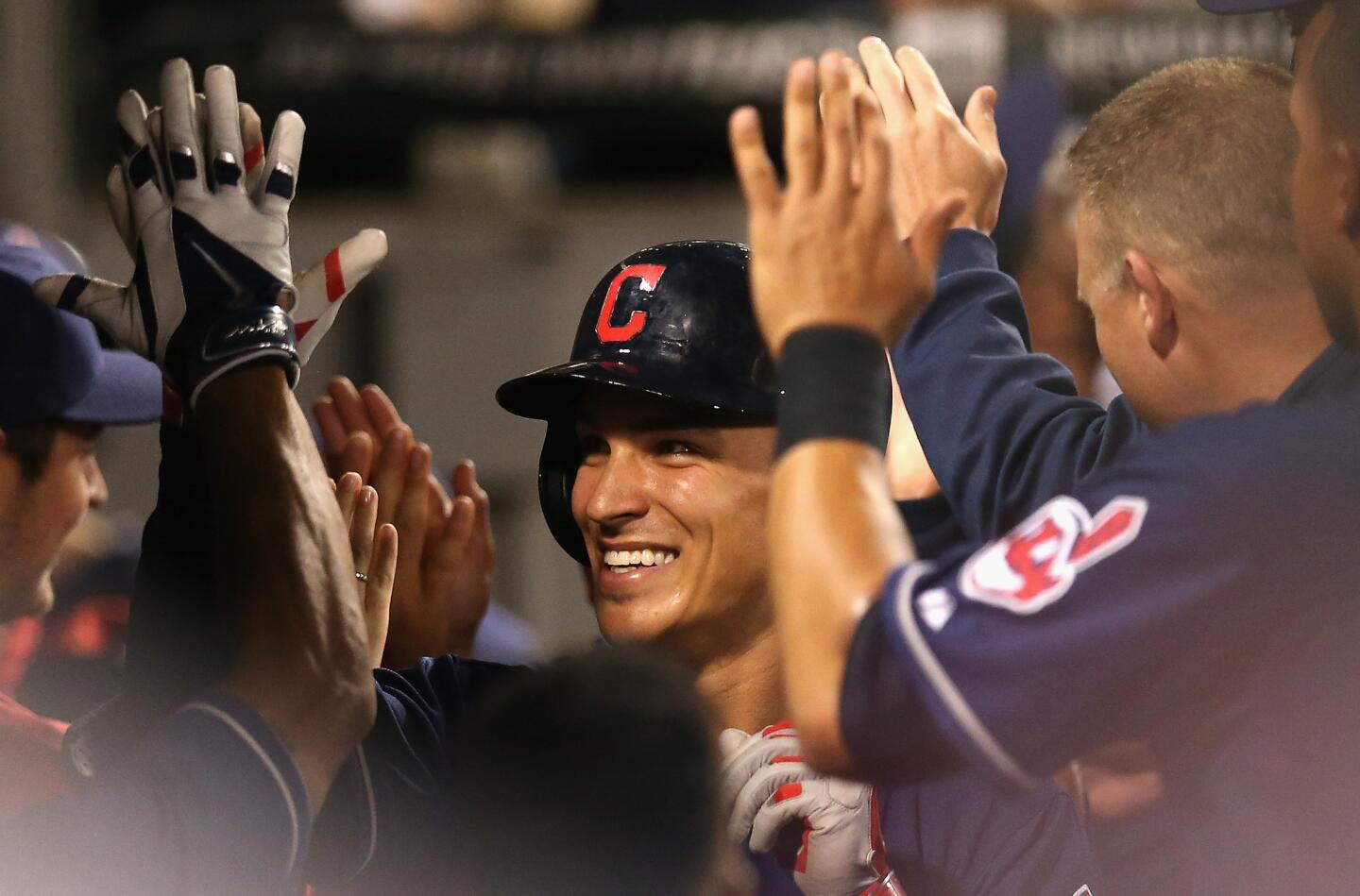 The Indians' Zach Walters is greeted by teammates in the dugout after hitting a two-run home run in the top of the 10th inning.
