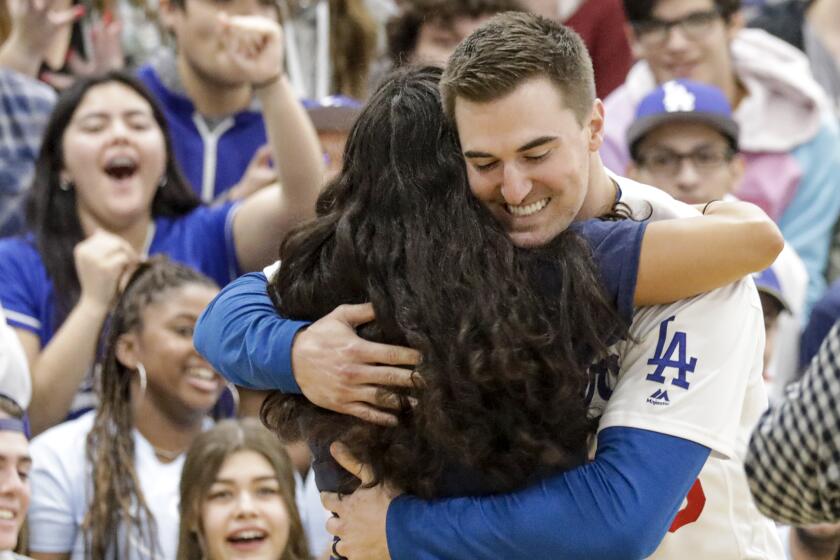 SANTA CLARITA, CA - JANUARY 24, 2020 - Ross Stripling gives hug to a student. Students give a warm welcome to Los Angeles Dodgers players at Saugus High School during an all-school pep rally. (Irfan Khan / Los Angeles Times)