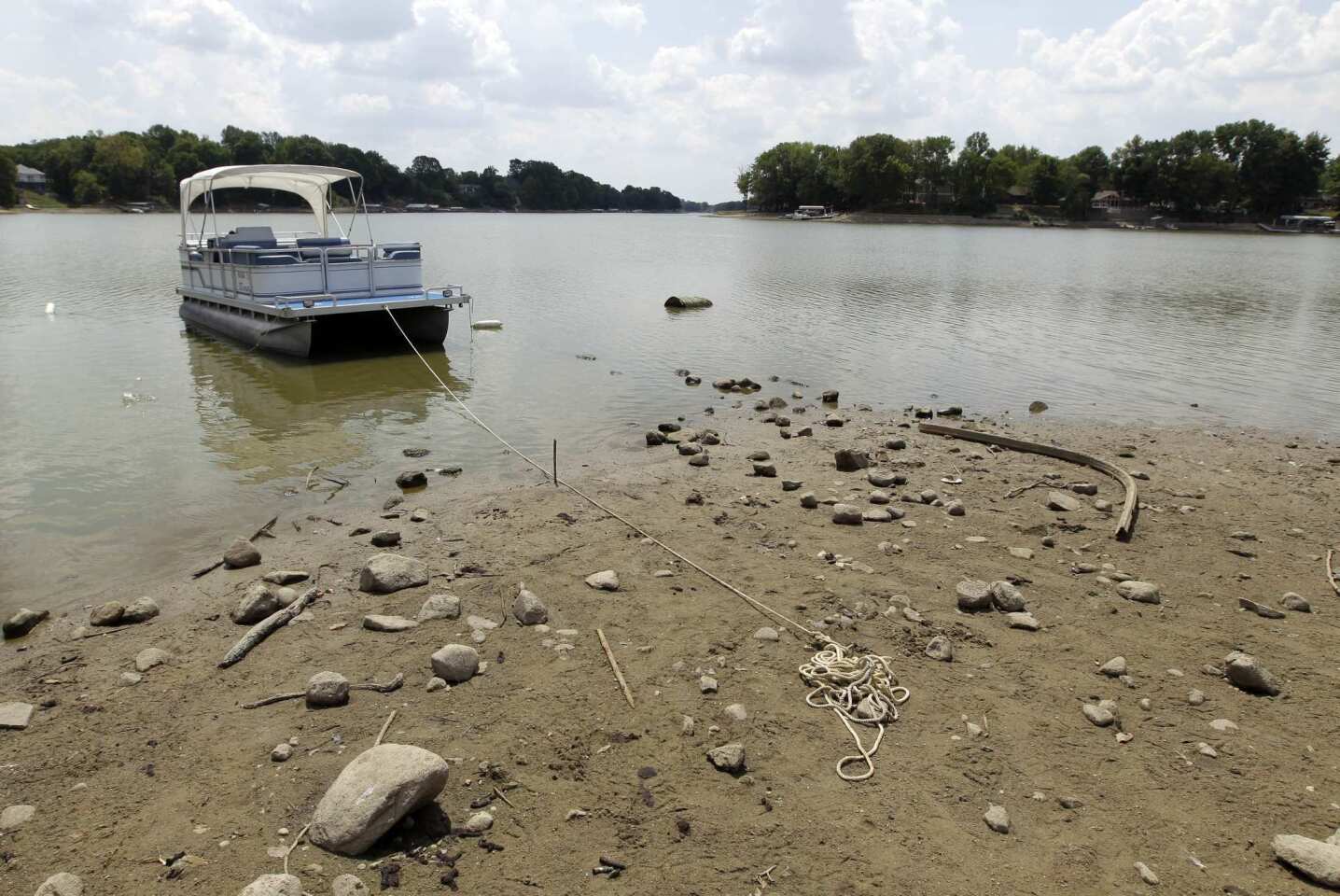 A boat is anchored in the mud because the owner couldn't reach the dock at Morse Reservoir in Noblesville, Ind.