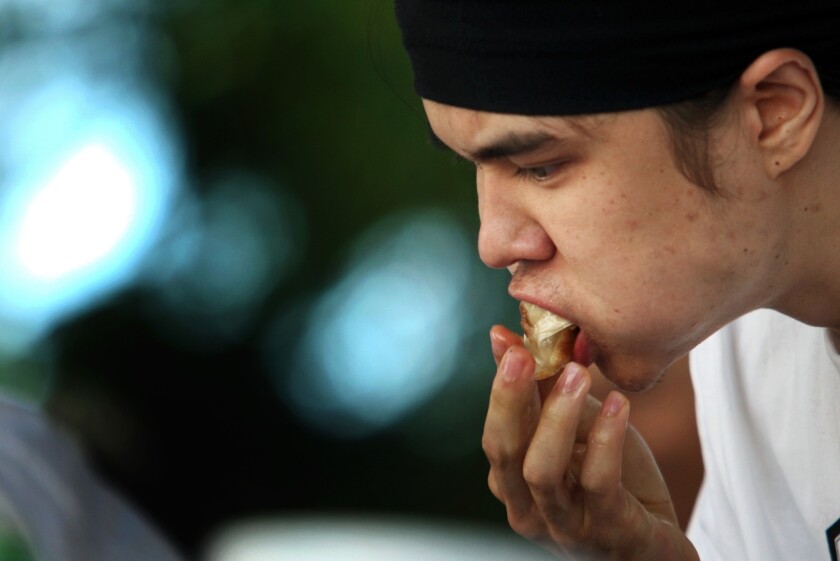 Competitive eater Matthew Stonie stuffs his mouth with gyoza during the Day-Lee Foods World Gyoza Eating Championship in 2013.