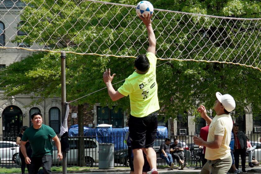 Brooklyn, New York - May 16: An ecuavoley player aims the ball over the net during the inner-borough championship at Morocho Volleyball League in Maria Hernandez Park.