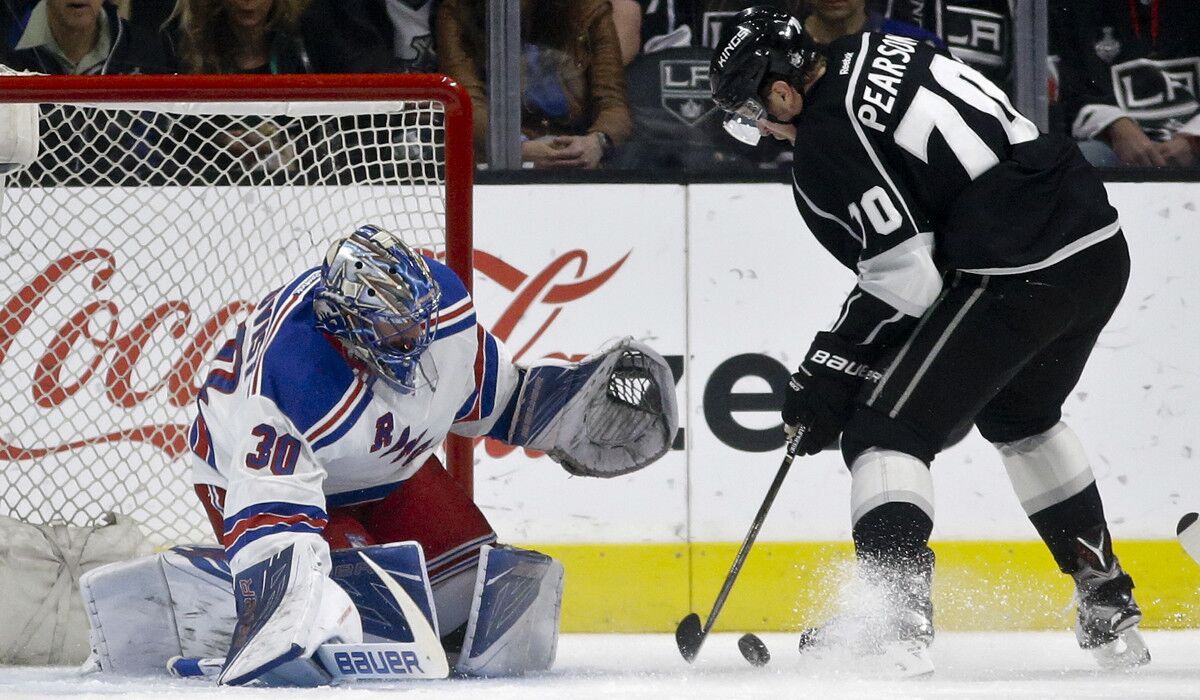 New York Rangers goalie Henrik Lundqvist, left, blocks a shot by Los Angeles Kings left wing Tanner Pearson during the first period on Thursday.