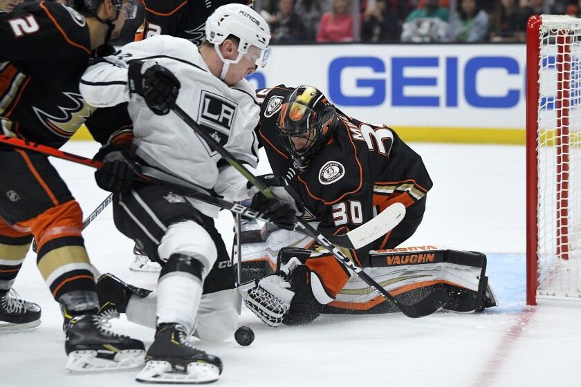 Kings center Jaret Anderson-Dolan, left, tries to get a shot past Ducks goaltender Ryan Miller during a preseason game Sept. 25 at Honda Center.